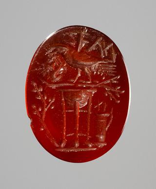 I203 Ravn siddende på en trefod flankeret af laurbærgren, bue og pilekogger