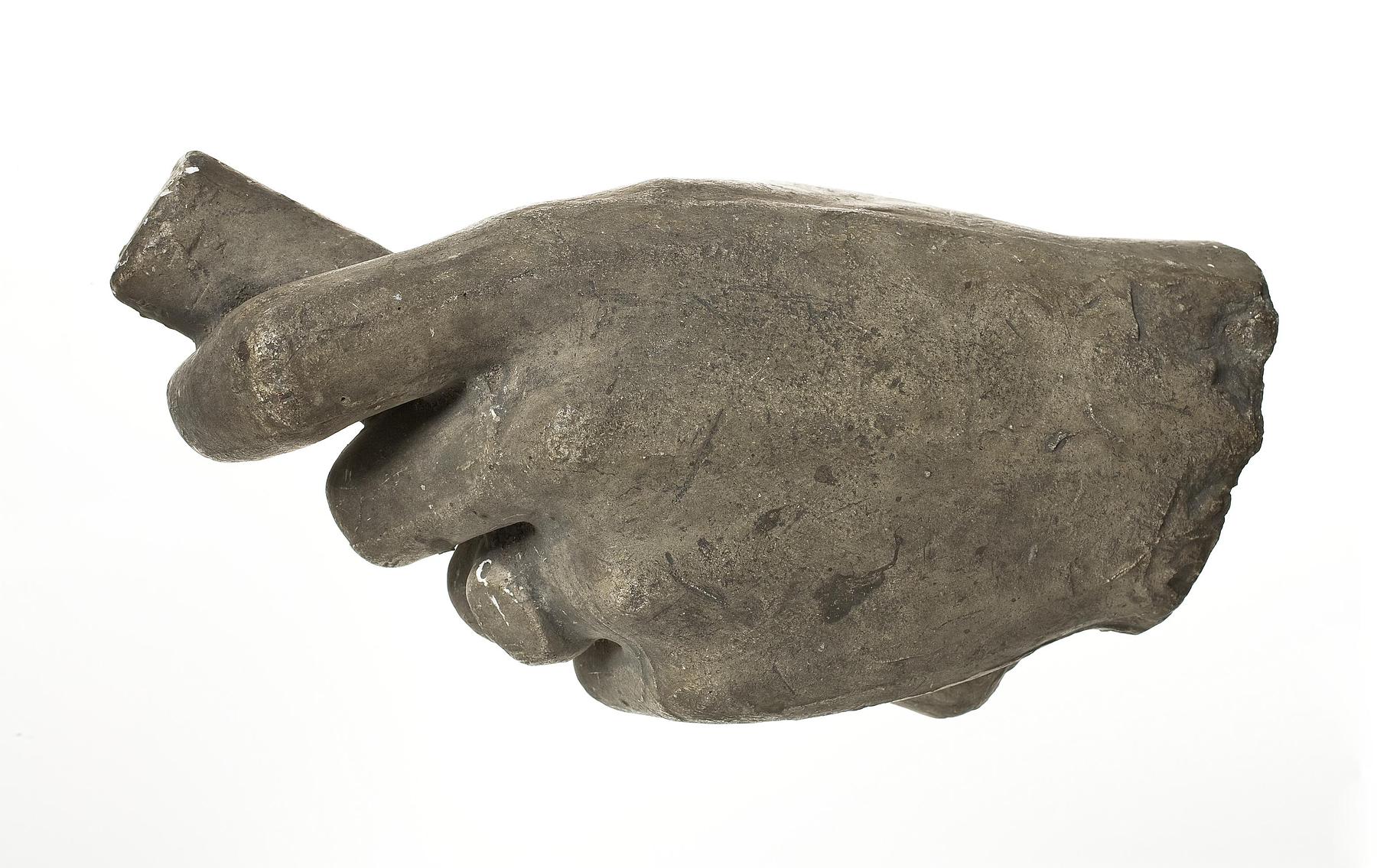 Left hand with ring holding an object, L92
