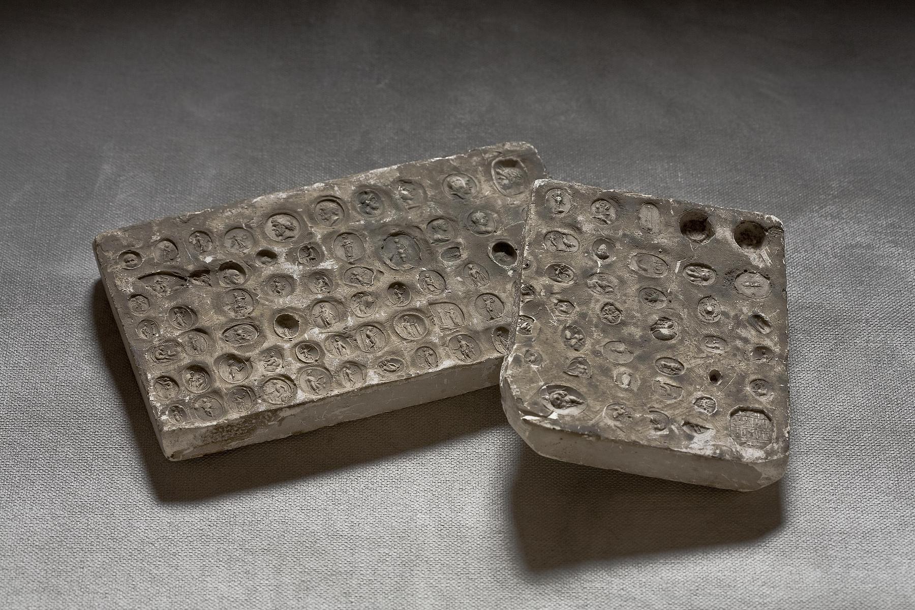 Fragment of a plaster block with 37 impressions of gems and pastes, L643