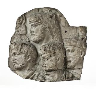 L327y Four heads of Roman soldiers