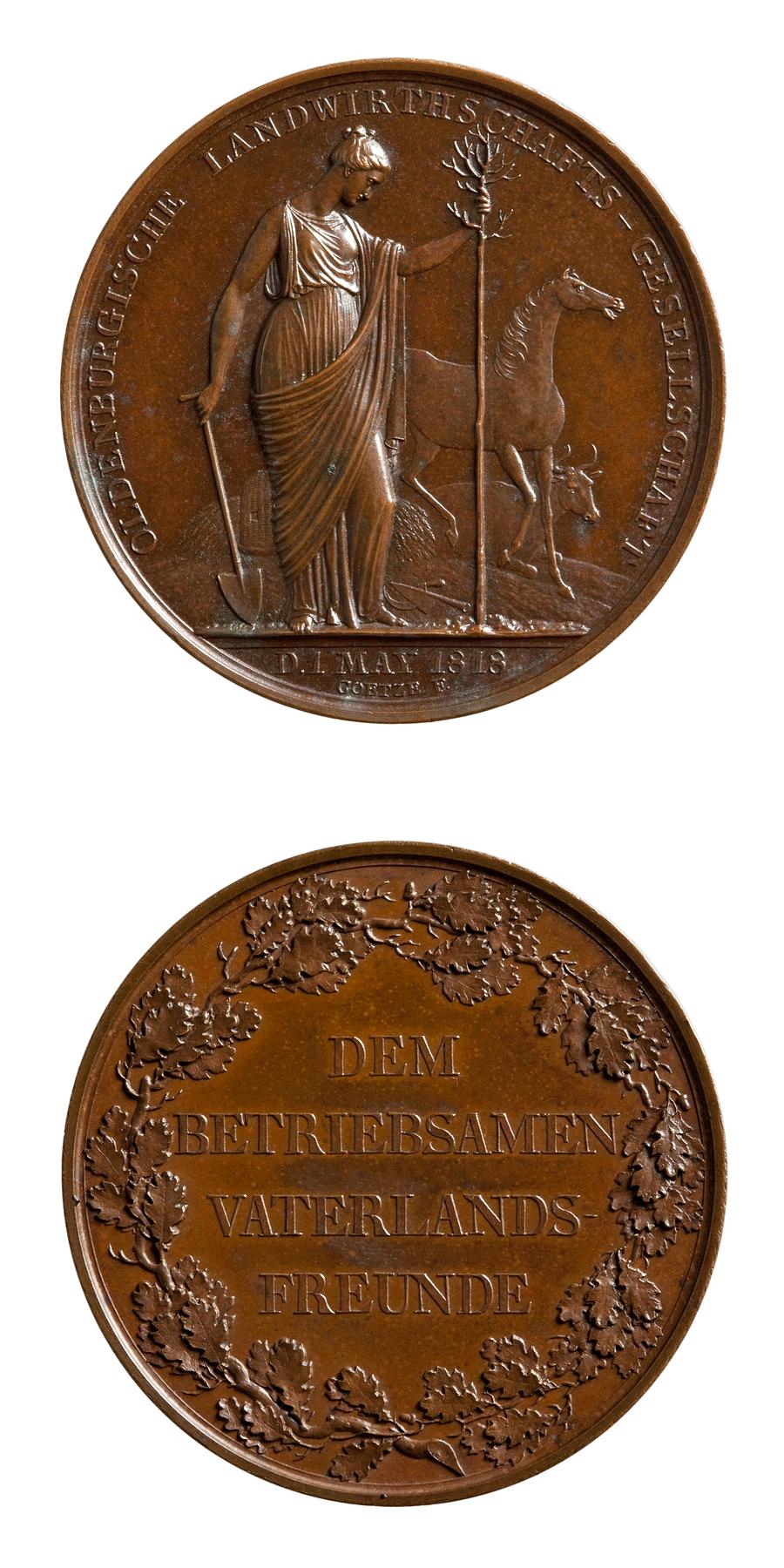 Medaljens forside: Landbruget planter et træ. Medaljens bagside: Egekrans og inskription, F88