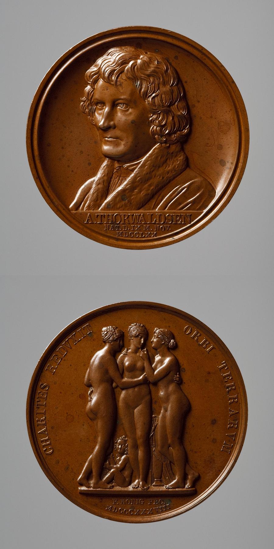 Medaljens forside: Portræt af Thorvaldsen. Medaljens bagside: Gratierne og Amor, F12