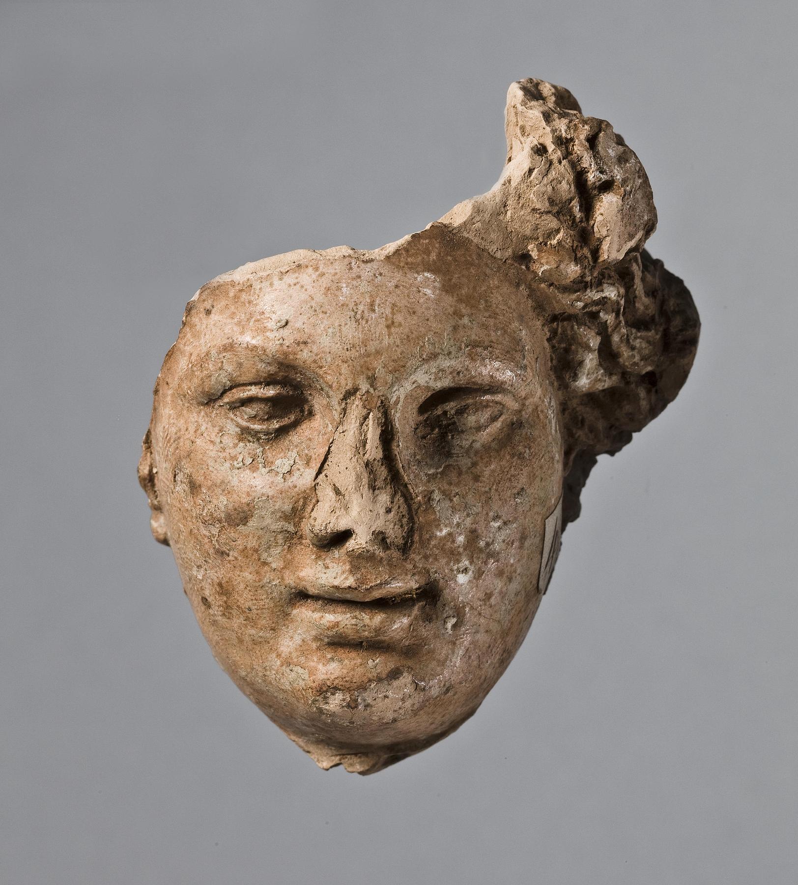 Relief (?) with a female head, H1041