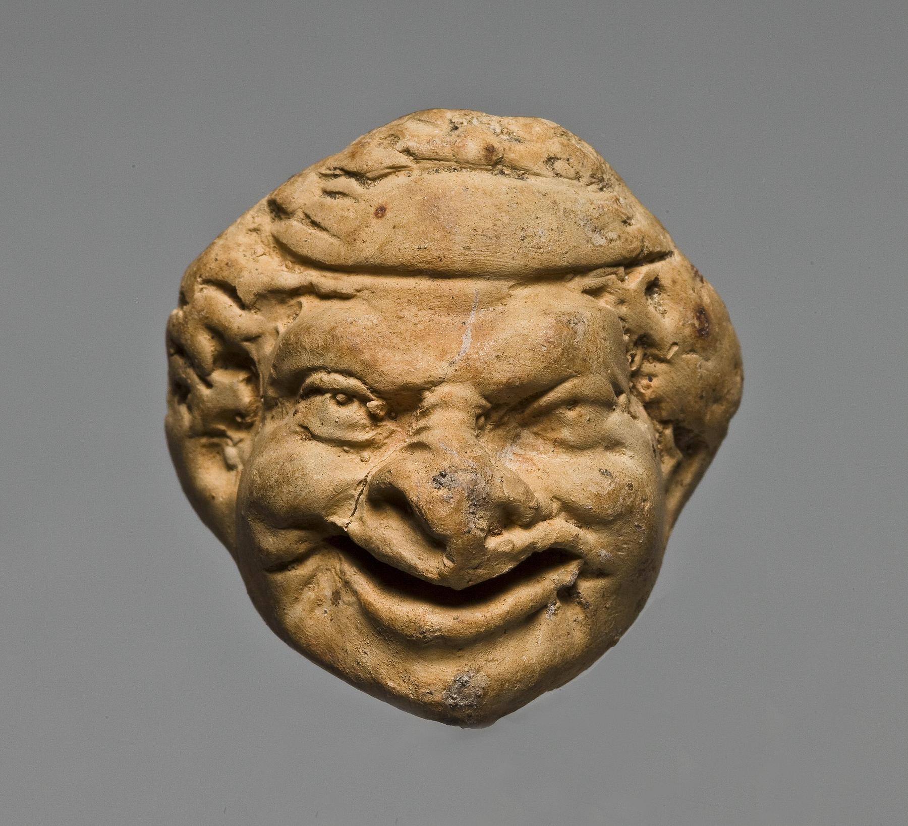 Miniature head with theatre mask, H1047