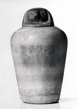 H387 Canopic jar with falcon-headed lid and hieroglyphic inscription