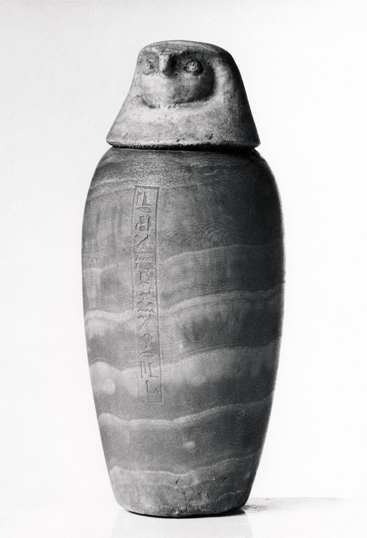 Canopic jar with falcon-headed lid and hieroglyphic inscription, H388