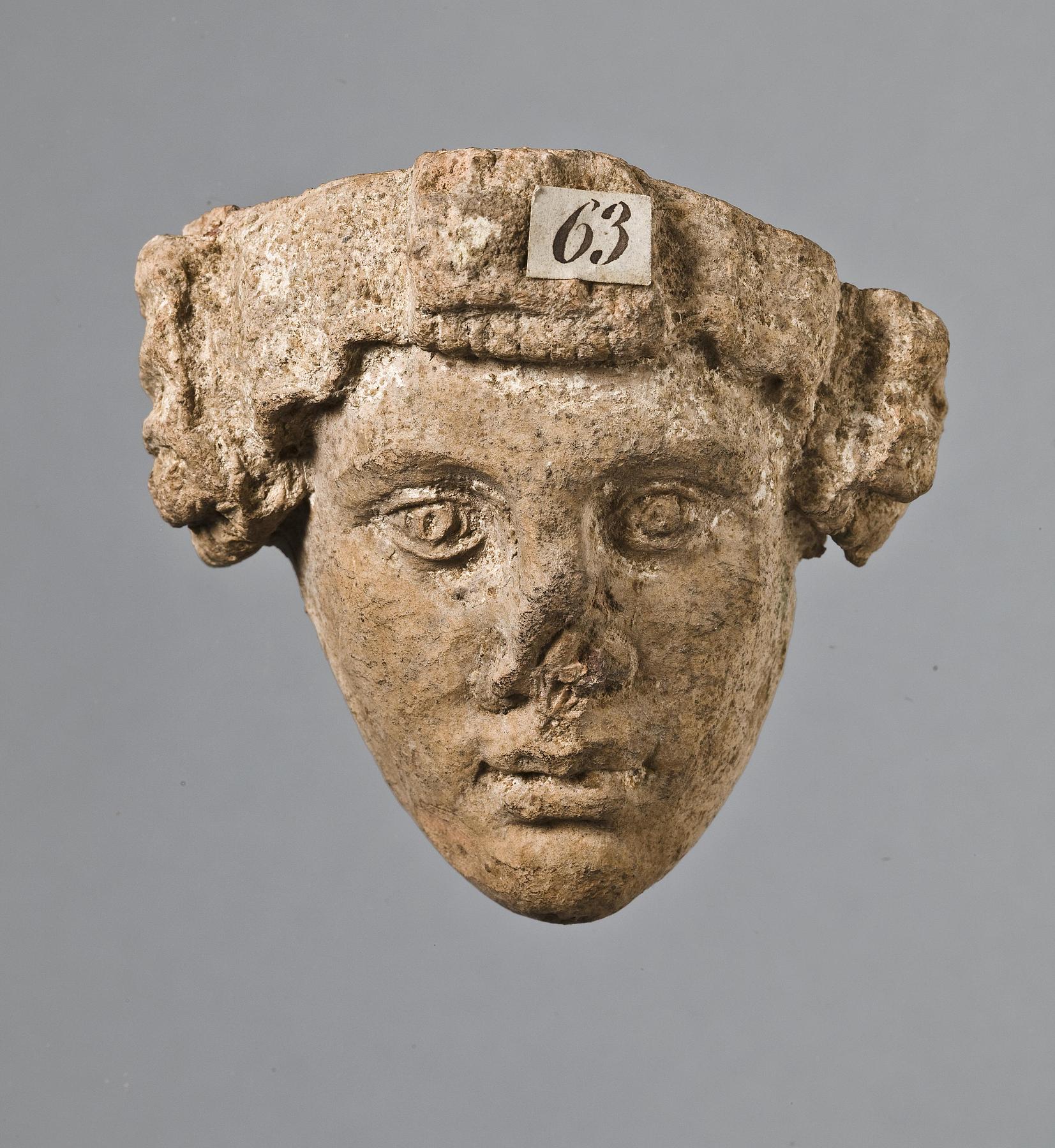 Relief (?) with a female head, H1063