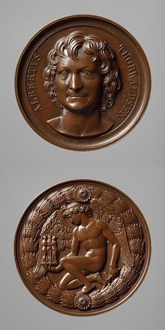 F4 Medal obverse: Portrait of Thorvaldsen. Medal reverse: The Genius of Sculpture kneeling, holding hands with The Graces and Cupid