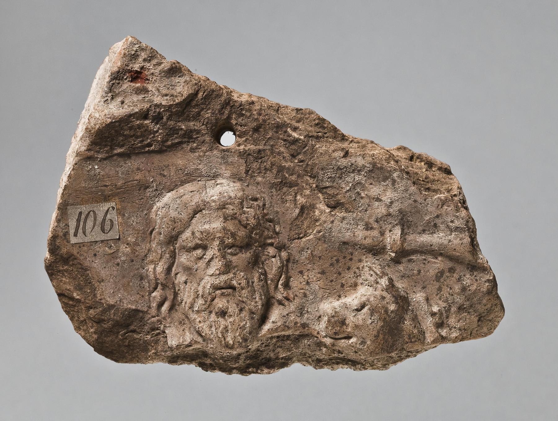Campana relief with bearded male head and griffin's head, H1106