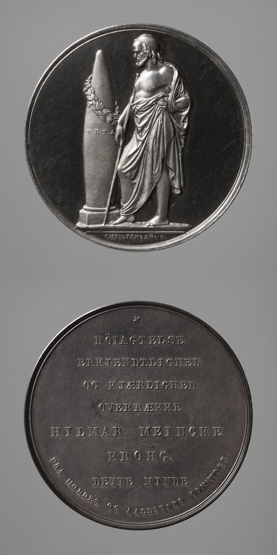 Medaljens forside: En olding stående ved målet. Medaljens bagside: Inskription, F56