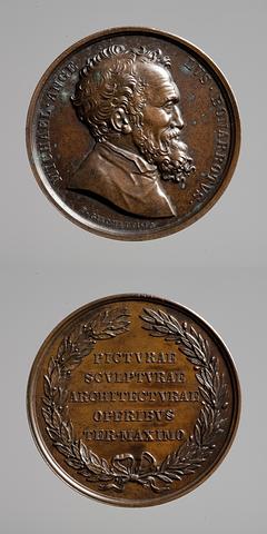 F84 Medaljens forside: Michelangelo. Medaljens bagside: Inskription, krans af olivengren og laurbærgren