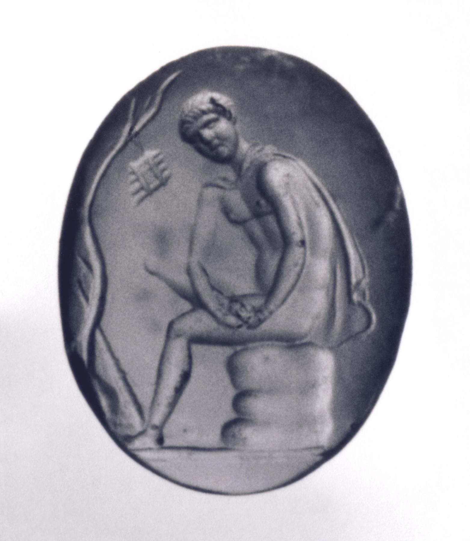 Seated man extracting a thorn from his foot, I1165
