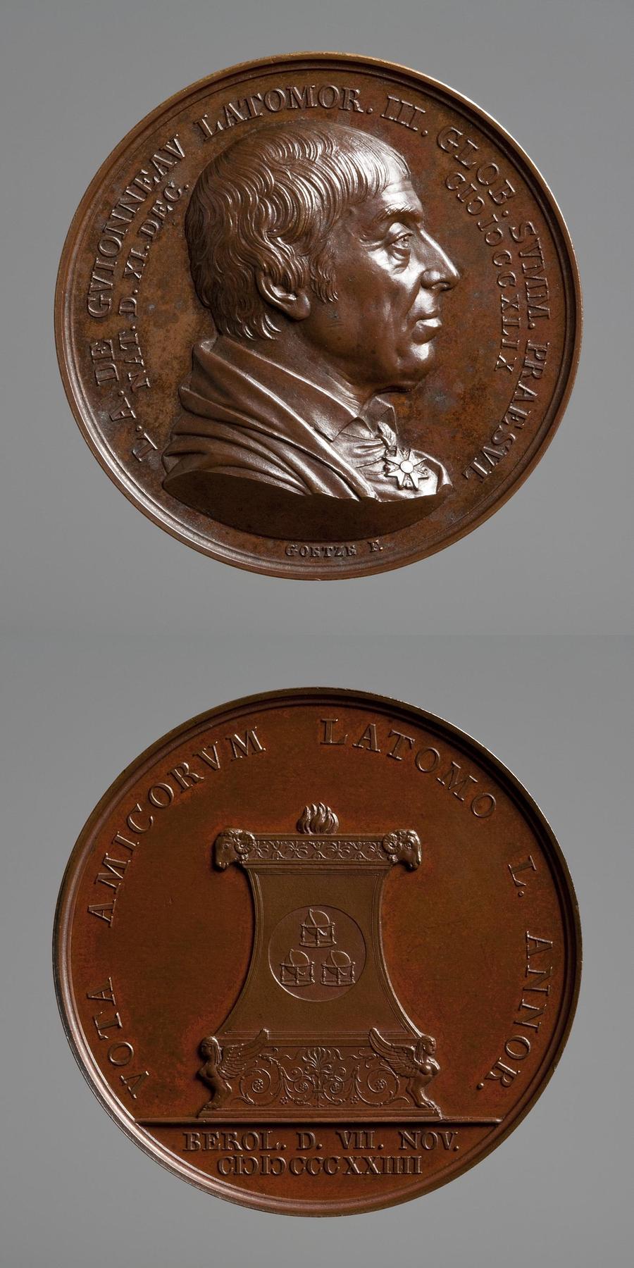 Medaljens forside: Frimureren Guionneau. Medaljens bagside: Alter med brændoffer og tre glober, F90