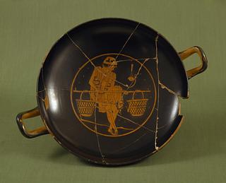 H605 Kylix with a youth carrying a pole with two baskets