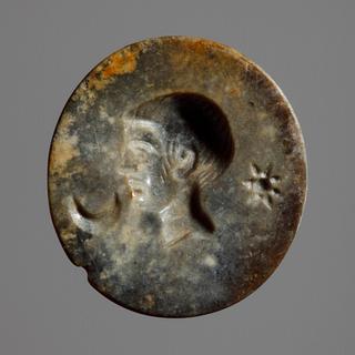 I1054 Head of a young man between a star and a crescent