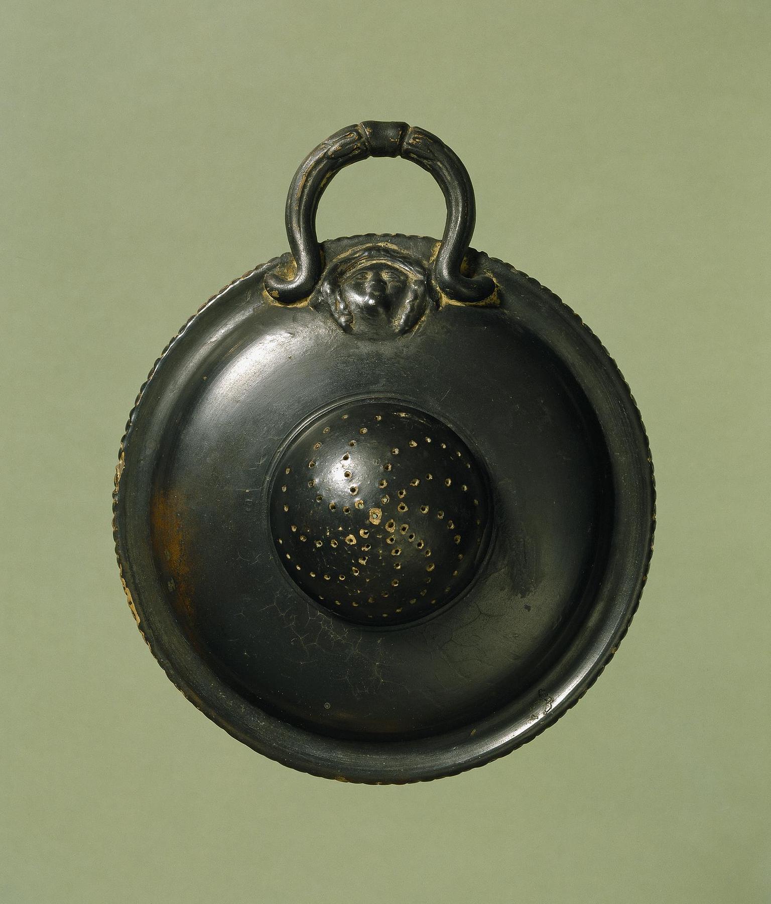 Strainer with relief decoration of a female head, H771