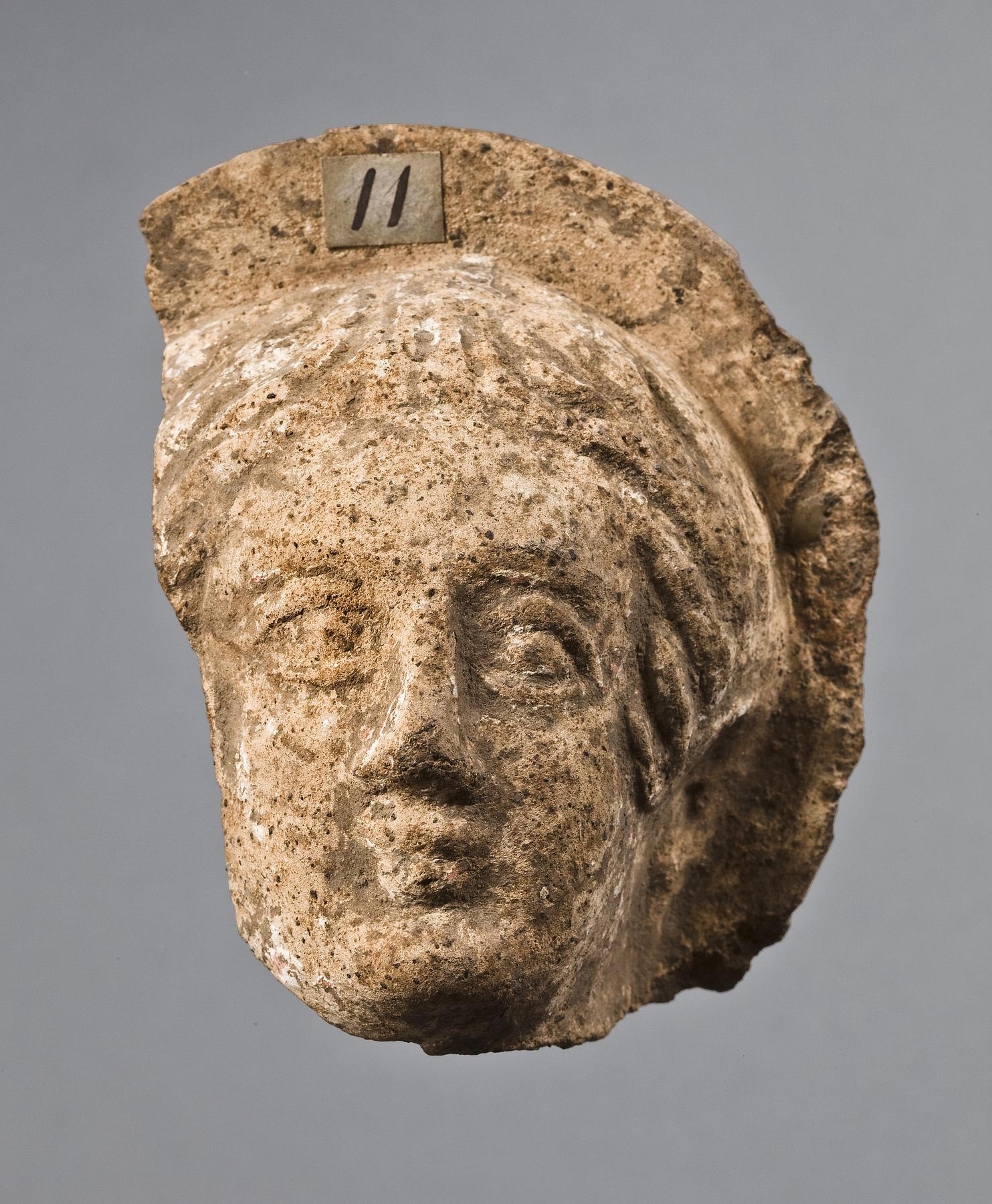 Votive head of a woman, H1011