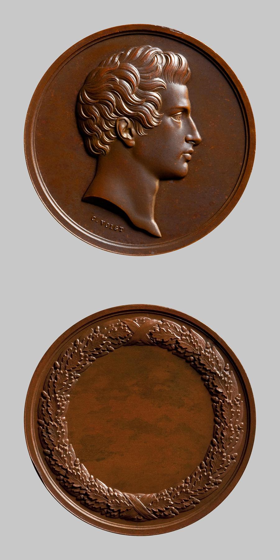 Medaljens forside: Ung mands portræt. Medaljens bagside: Egekrans, F129