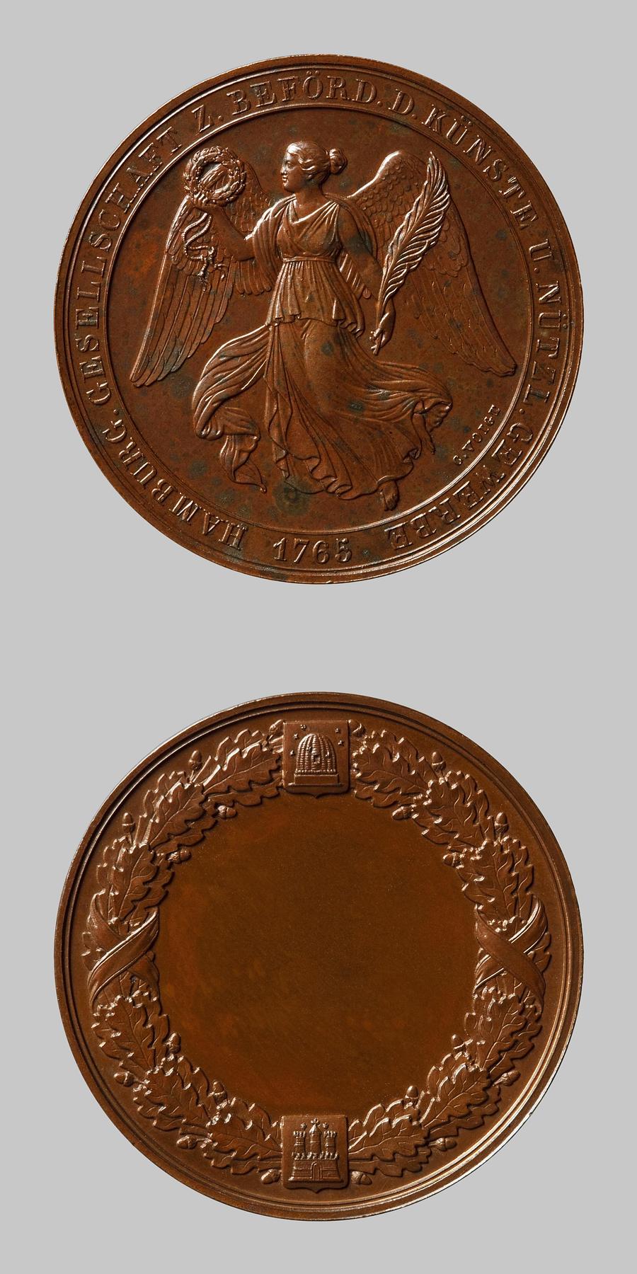 Medaljens forside: Victoria svævende med palmegren og krans. Medaljens bagside: Egekrans, skjold med en bikube og Hamborgs byvåben, F130