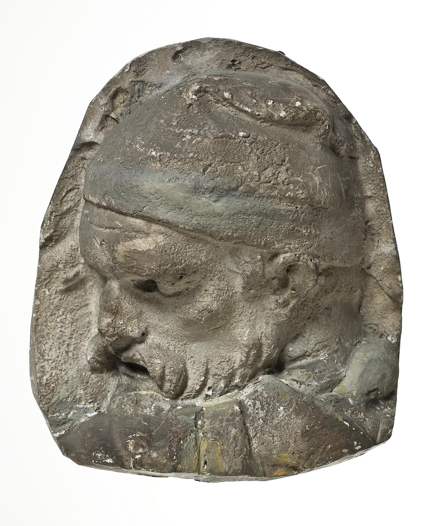 Heads of Dacian warriors wearing caps, L331t